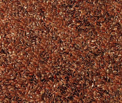 Flax seed cereal and grain texture as a symbol of healthy eating by growing and eating high fiber brown organic flaxseed as a health freindly whole food choice.