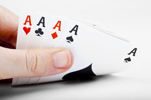 Hand of Four Aces over a white background.