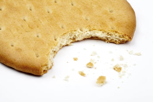 Half-eaten biscuit over a white background.