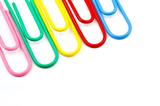 Abstract shot of Paper Clips over a white background.