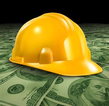 Construction business with a yellow hardhat helmet on a floor of money and currency representing the economic condition of commercial and residential building activity and investment.