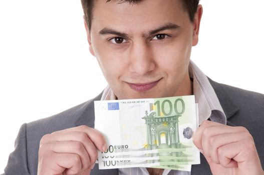 smiling young man showing 100 euro bills isolated on white background