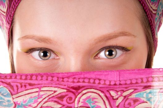 Young woman with covered face by scarf close-up