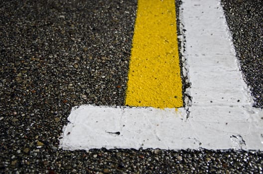 wet asphalt with white and yellow lines background