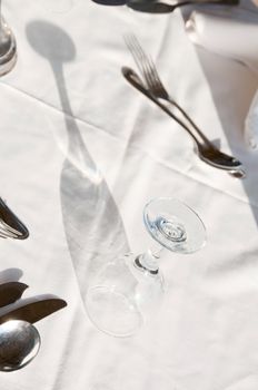 Dining tables ready for customers, outdoor evening. Shallow depth of fields, focus on the glass top.