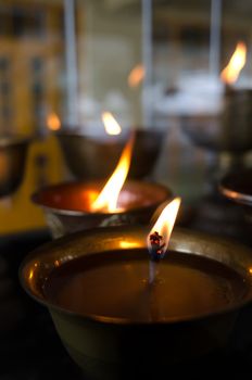 Flame on lamp light oil in Buddhist temple