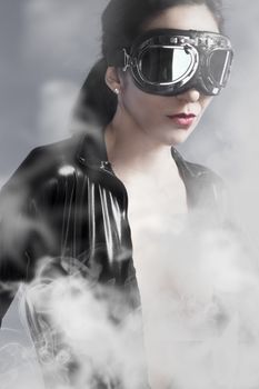 Sensual woman with sun glasses over smoke background