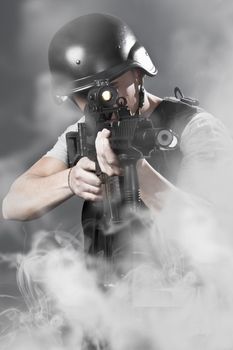 Army man over smoke background holding a machine gun