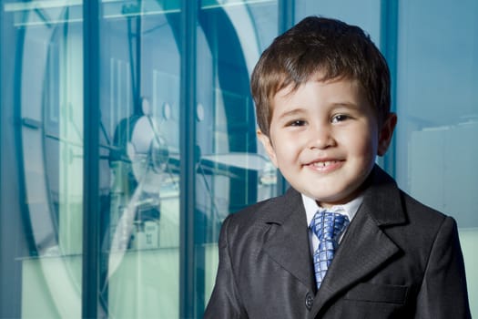 Child dressed businessman with funny face. smiling