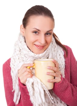 Young woman with big cup in red winter sweater and scarf on white background