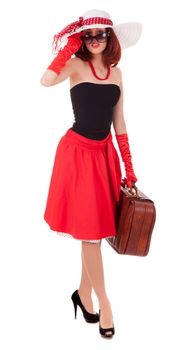 Full-length girl in retro style with suitcase and big hat on white background