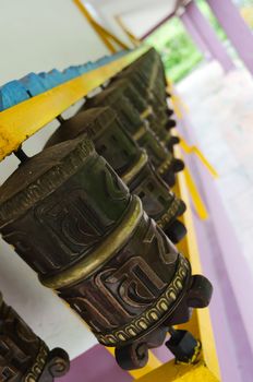 Prayer Buddhism wheels in a row. Focus on the front wheel.