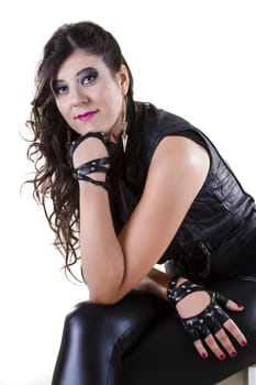 View of a beautiful girl in dark leather clothes against a white background.