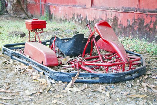 Horizontal landscape of a dismantled go cart that has seen better days and ready for scrap. Shot location, Goa India