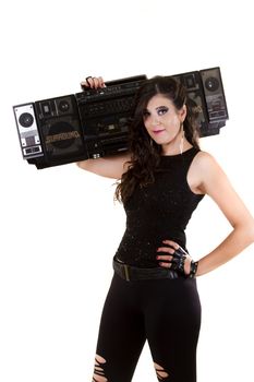 View of a beautiful girl in dark leather clothes against a white background holding a large retro radio.