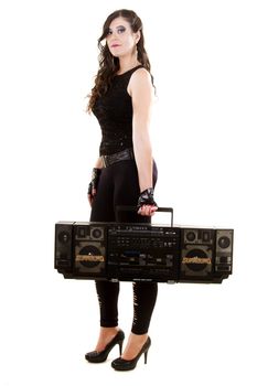 View of a beautiful girl in dark leather clothes against a white background holding a large retro radio.