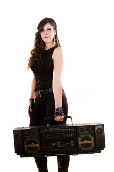 View of a beautiful girl in dark leather clothes against a white background holding a large retro radio.