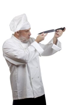 Portrait of a caucasian chef in his uniform on a white background.