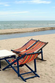 sun beach chairs on shore near sea