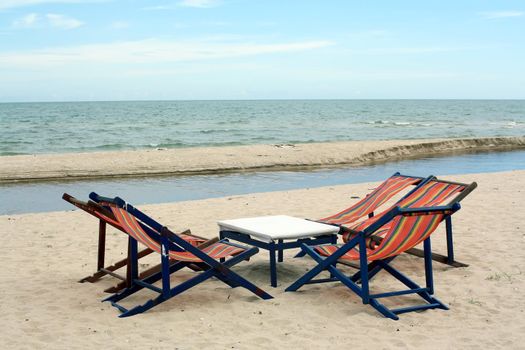 sun beach chairs on shore near sea