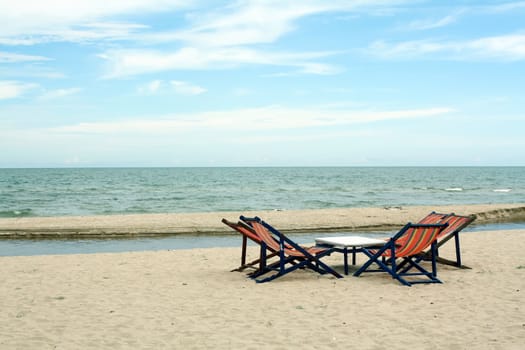 sun beach chairs on shore near sea