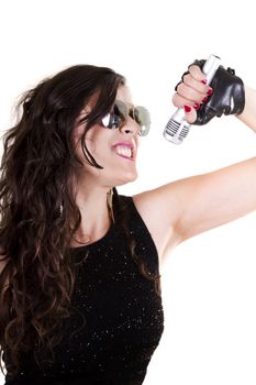 View of a beautiful girl in dark leather clothes against a white background holding a microphone.