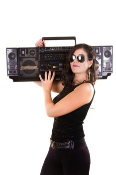 View of a beautiful girl in dark leather clothes against a white background holding a large retro radio.