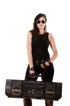 View of a beautiful girl in dark leather clothes against a white background holding a large retro radio.