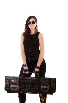 View of a beautiful girl in dark leather clothes against a white background holding a large retro radio.