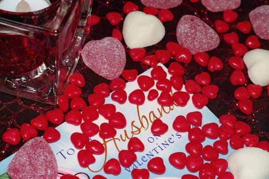 Candy and card ready for Valentine's Day with a candle