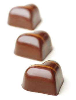 Heart shaped Chocolate Pralines on a white background.
Soft Focus.