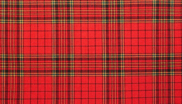 Textiles. Bright red plaid  fabric as natural background