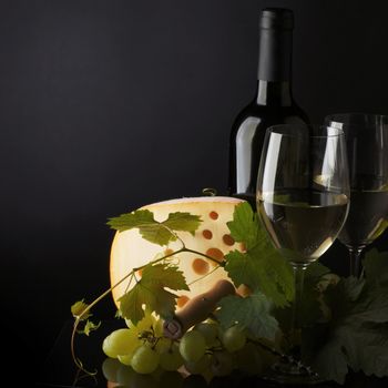 white wine and cheese on black
