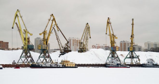 Cranes in Northern river port. Moscow. Winter.