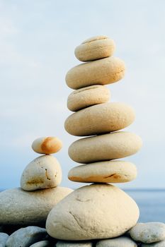 White stack of zen stones on the beach