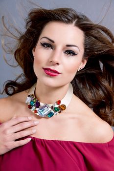 attractive brunette woman with glamour jewellry and make up portrait