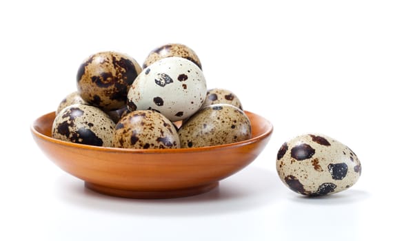 Quail eggs in bowl, isolated on white background.