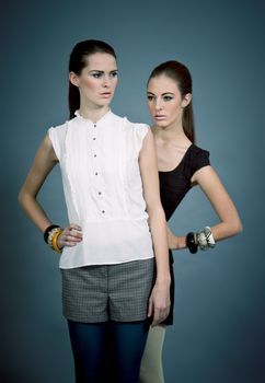 two beutiful brunette girls in casual fashion and accessory  portrait