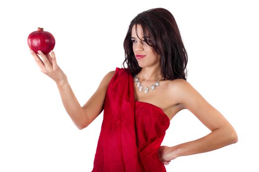 View of a beautiful girl holding a pomegranate.