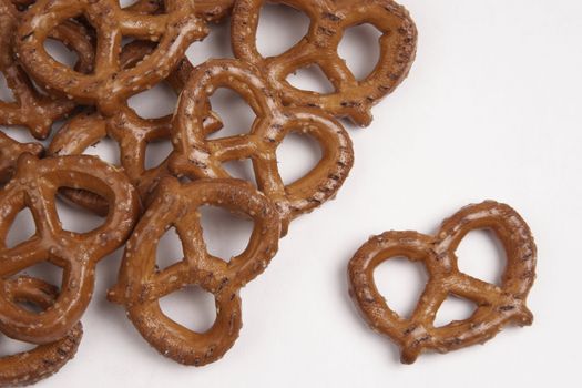 A horizontal composition of pretzels flowing in from the left
