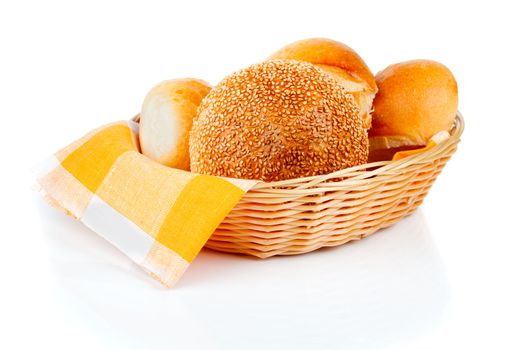 fresh baked buns in a basket on white background
