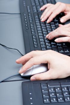 male hand on keyboard typing and scroll mouse on office desk
