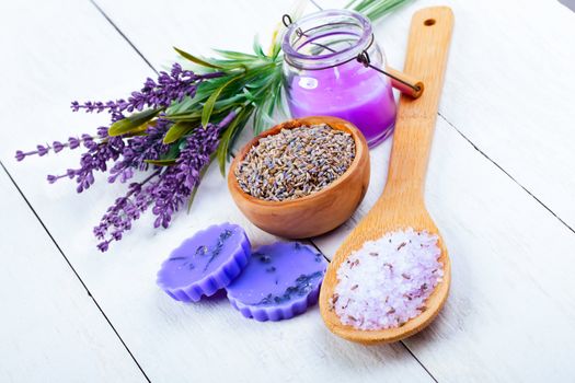 dry Lavender herbs, bath salt and candle, on white wooden table