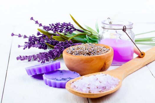 dry Lavender herbs, bath salt and candle, on white wooden table