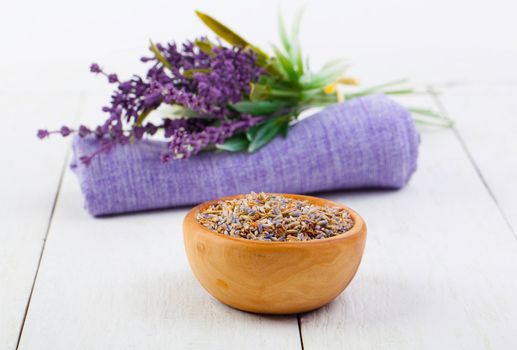 dry Lavender herbs, and flowers on the serviette, on white wooden background