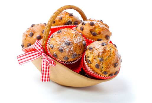 Muffins in a basket isolated on white background