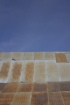 corrugated steel roofing with blue skies