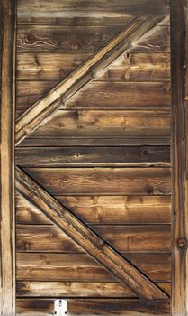 Old barn door wood textured with slanted braces