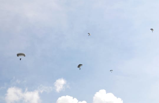 Group of parachutes against a blue sky