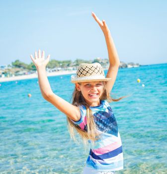 Cute girl in hat on the beach